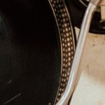 Laminate Vs. Vinyl - A record player with a record on it