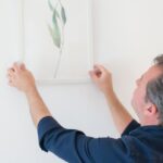 Wall Removal - Man in Blue Long Sleeve Shirt Holding White Frame on the Wall