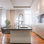 Built-In Furniture - Interior of spacious kitchen with modern minimalist furniture with built in appliances and dining zone in contemporary apartment in daylight
