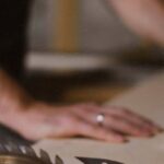 Table Saws - Unrecognizable blurred male master cutting wooden plank using table saw with sharp knives while working in professional workshop with special instruments