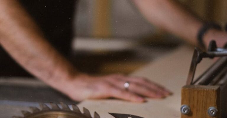 Table Saws - Unrecognizable blurred male master cutting wooden plank using table saw with sharp knives while working in professional workshop with special instruments