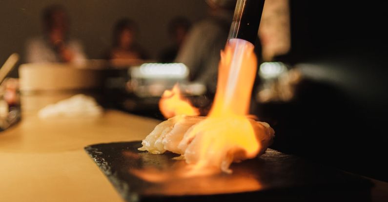 Radiant Heating - A person is cooking a piece of food on a grill