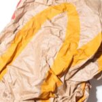 Garbage Disposal - Top view of crumpled empty craft paper bag of fast food restaurant placed on white background illustrating recycle garbage concept