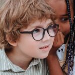 Garden Privacy - Girl Whispering to Boys Ear at Birthday Party in Garden